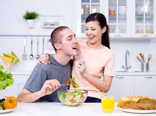 a woman feeds a man with products that naturally increase potency