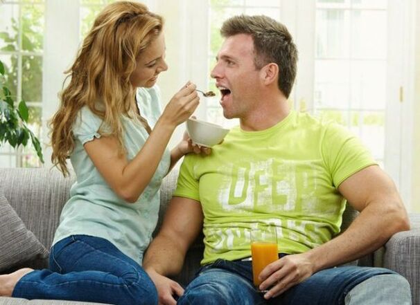 a woman feeds a man products designed to increase potency